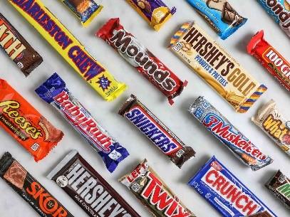 An assortment of chocolate candy bars sits against a white background.
