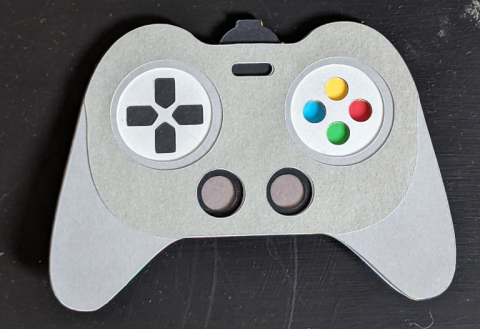 Gray cardstock box made to look like a video game controller